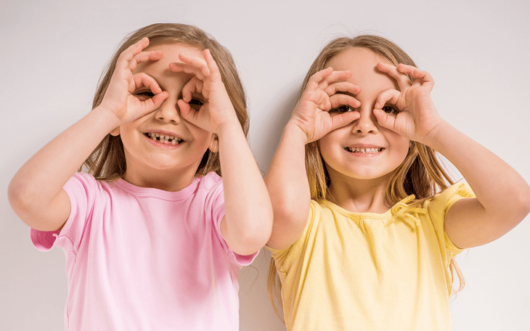 sisters looking through hands